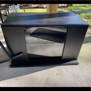 Black television stand with glass door